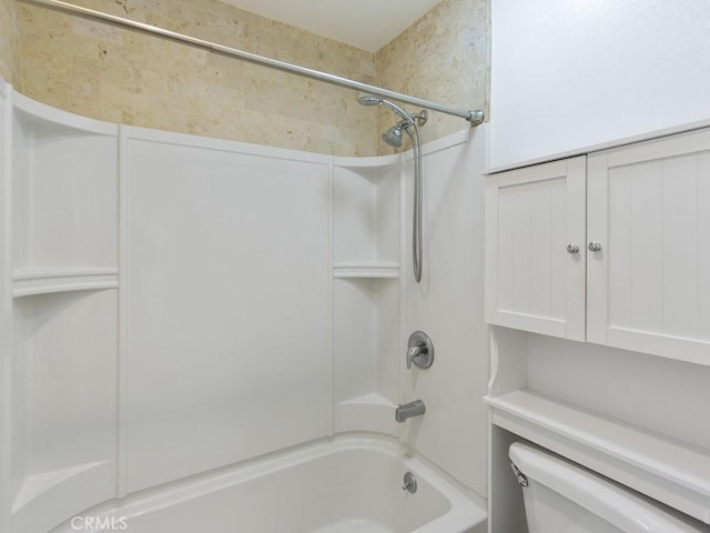 bathroom with shower / washtub combination and toilet