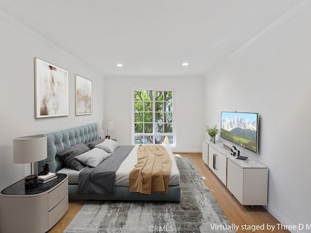 bedroom featuring light hardwood / wood-style floors and crown molding