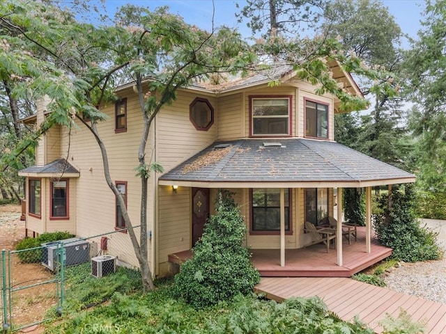 back of property featuring a deck and central air condition unit