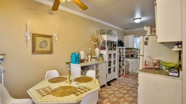 kitchen featuring white cabinetry and ornamental molding