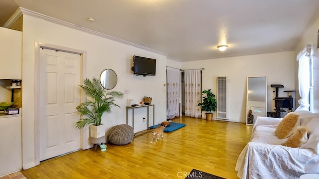 living room with ornamental molding and hardwood / wood-style flooring