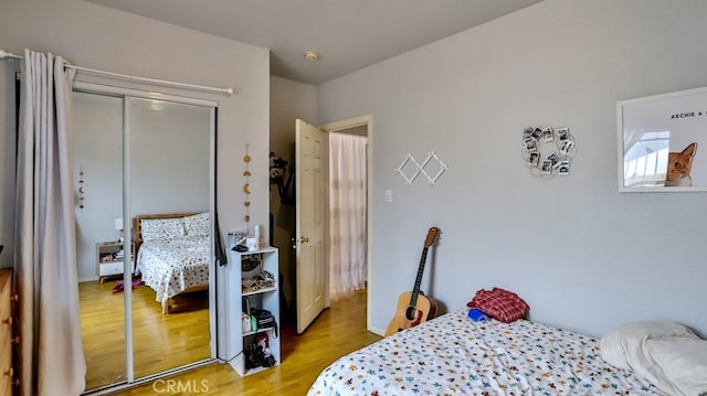 bedroom featuring light wood-type flooring and a closet