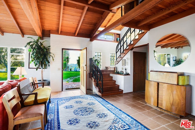 tiled foyer with wood ceiling and lofted ceiling with beams