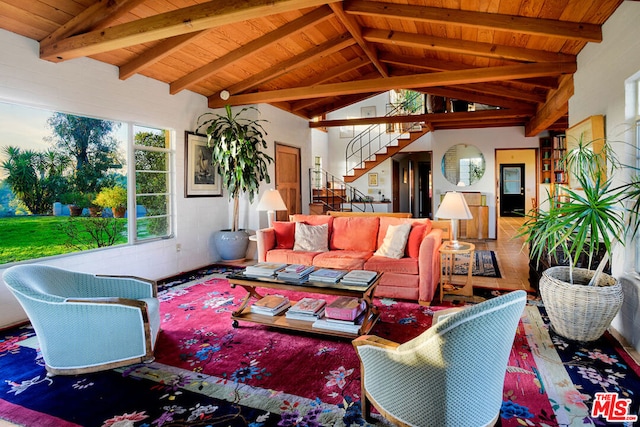 living room featuring lofted ceiling with beams and wooden ceiling