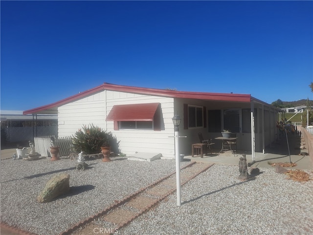 view of side of home featuring a patio area