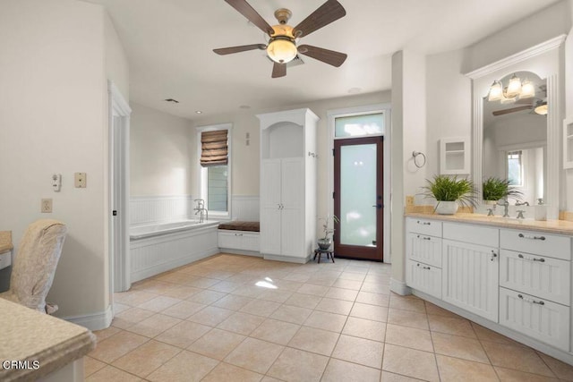 bathroom featuring a tub to relax in, vanity, tile patterned flooring, and ceiling fan