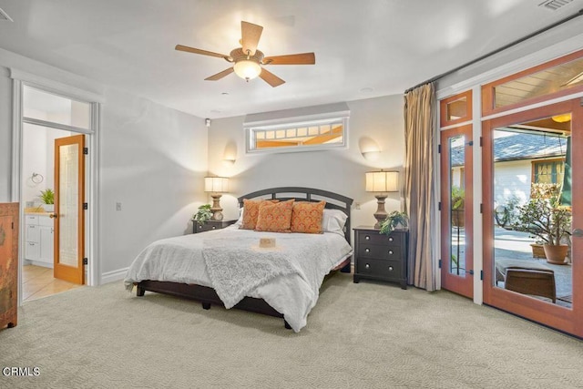 carpeted bedroom featuring ceiling fan, ensuite bath, and access to exterior