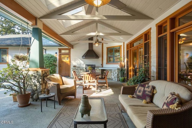 sunroom featuring ceiling fan and vaulted ceiling with skylight