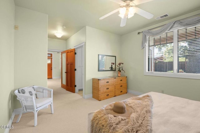 bedroom with ceiling fan and light carpet