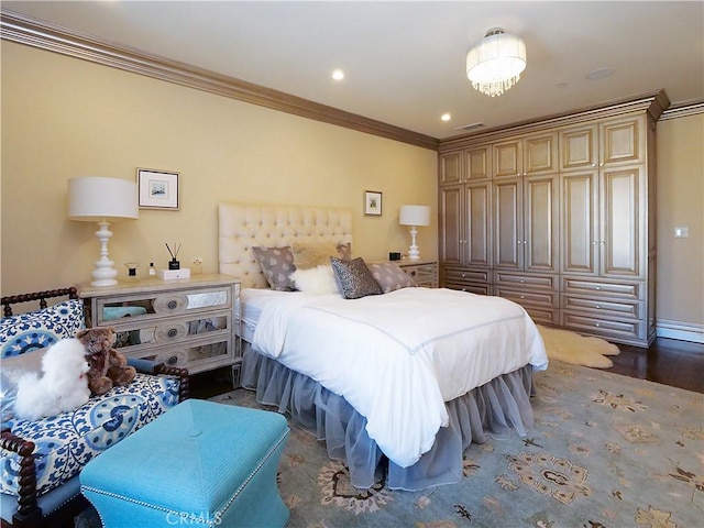 bedroom with ornamental molding, wood finished floors, visible vents, and recessed lighting