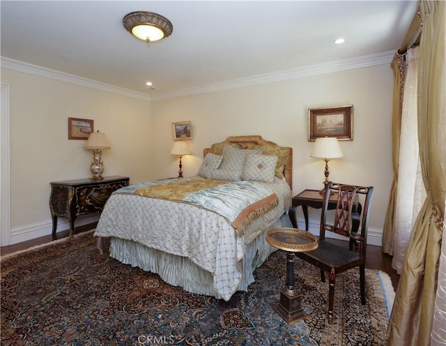 bedroom featuring ornamental molding, wood finished floors, and baseboards