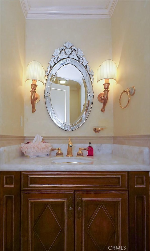 bathroom with ornamental molding and vanity