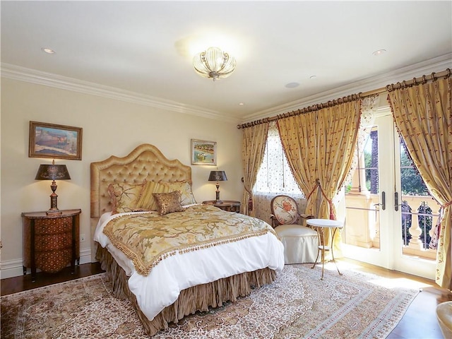 bedroom featuring access to exterior, crown molding, baseboards, and wood finished floors