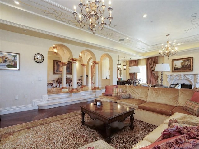 living room with arched walkways, a chandelier, wood finished floors, a tray ceiling, and crown molding