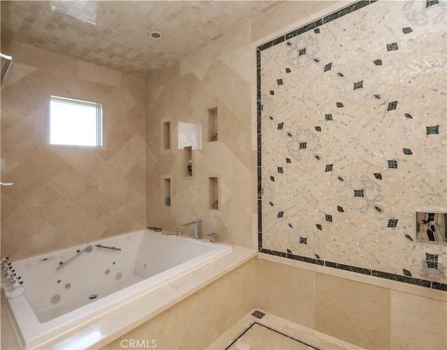 full bath with a jetted tub, tile patterned flooring, and tile walls