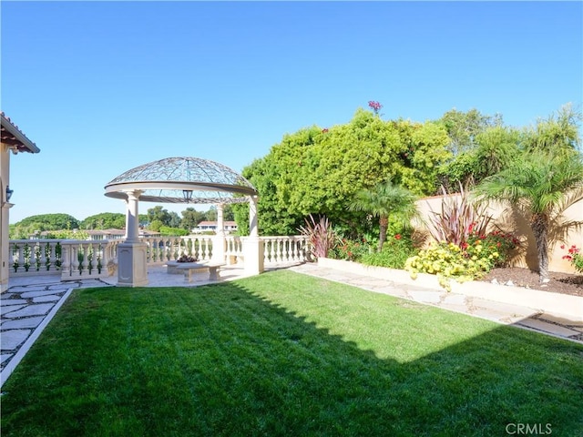 view of yard featuring fence and a gazebo