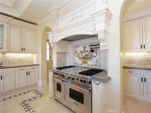 kitchen with range with two ovens, cream cabinetry, crown molding, light tile patterned floors, and custom range hood