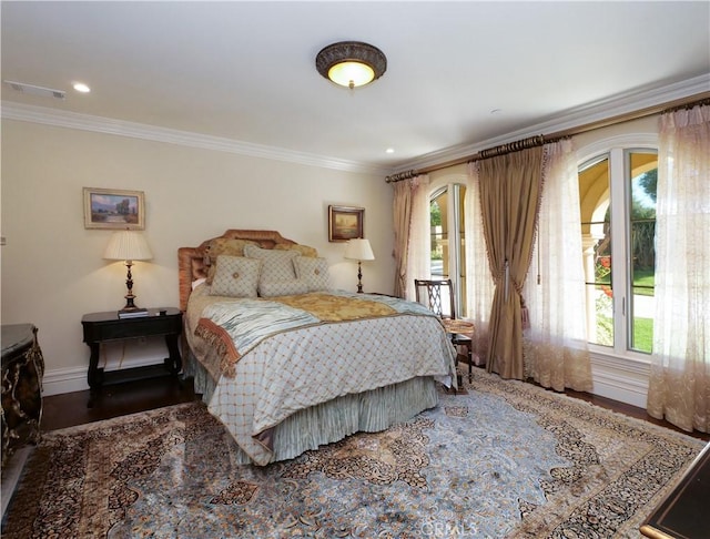 bedroom featuring ornamental molding, multiple windows, visible vents, and baseboards