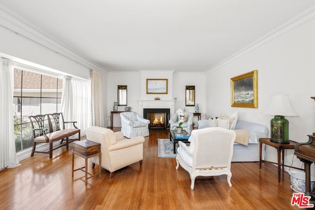 living room featuring light hardwood / wood-style flooring and crown molding