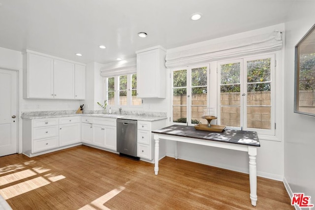 kitchen with white cabinetry, dishwasher, and light hardwood / wood-style flooring