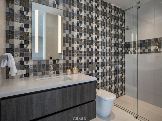 bathroom with tile walls, walk in shower, toilet, and vanity