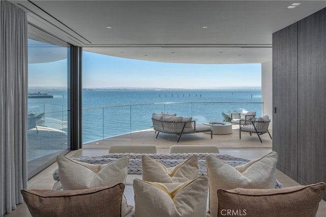 balcony featuring a water view and outdoor lounge area