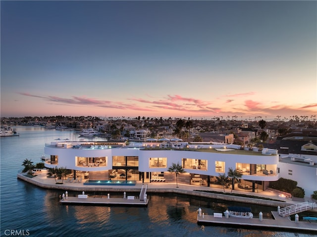 dock area featuring a water view, a patio area, and a pool