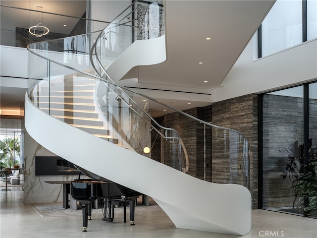 staircase featuring a high ceiling