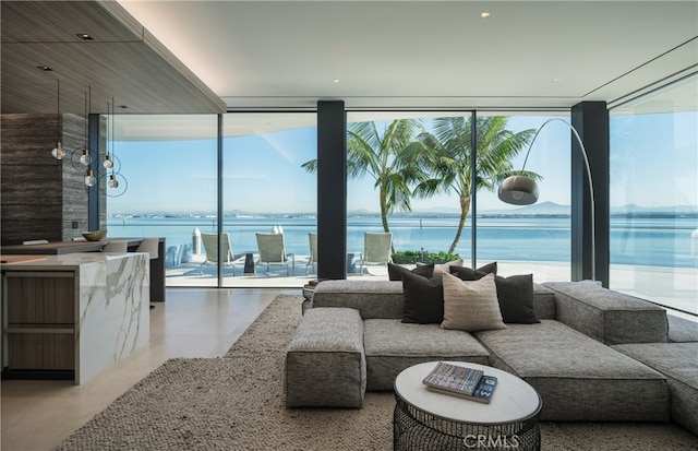 living room with floor to ceiling windows and a water view