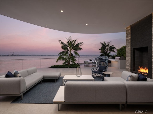 living room with a fireplace and a water view