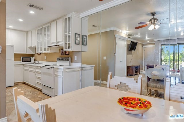 kitchen with ceiling fan, crown molding, white cabinets, and white appliances