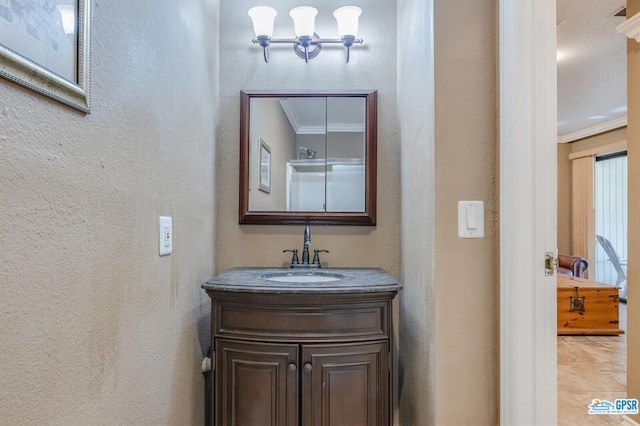 bathroom featuring crown molding and vanity