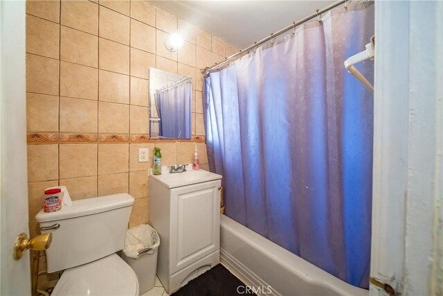 5965 W Blvd, Los Angeles, CA 90043 - full bathroom featuring sink, toilet, tile walls, and shower / tub combo with curtain