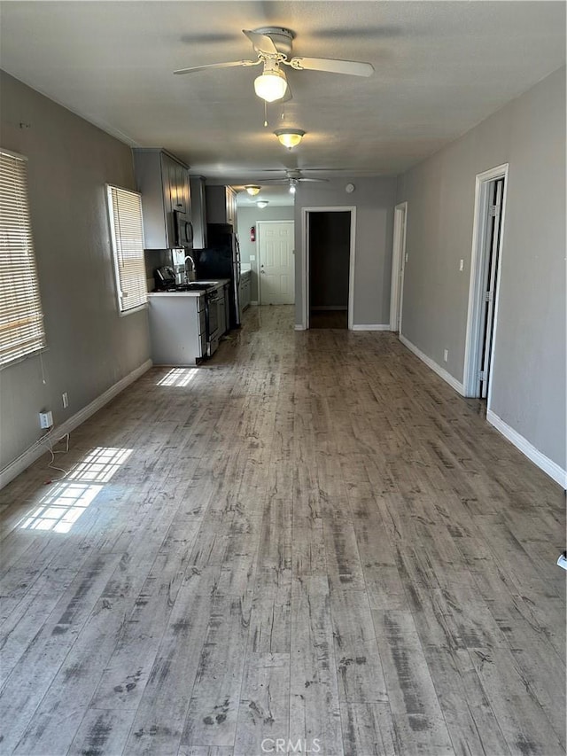5965 W Blvd, Los Angeles, CA 90043 - unfurnished living room featuring ceiling fan and light wood-type flooring