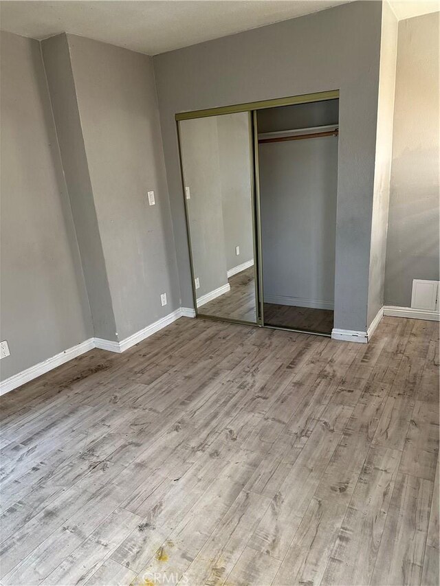 5965 W Blvd, Los Angeles, CA 90043 - unfurnished bedroom featuring light hardwood / wood-style floors and a closet