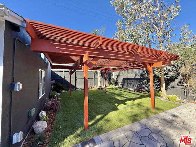 view of yard with a pergola and a patio