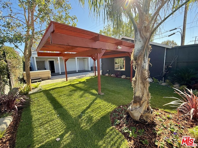 rear view of house featuring a lawn, a pergola, and a patio