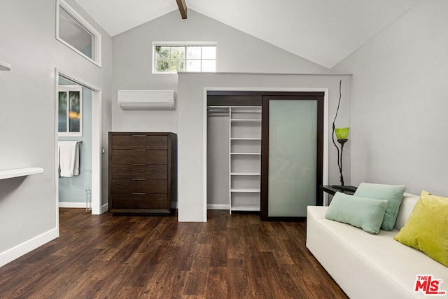 sitting room with lofted ceiling with beams, an AC wall unit, and dark wood-type flooring