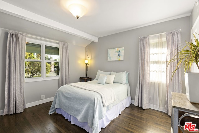 bedroom featuring beam ceiling and dark wood-type flooring