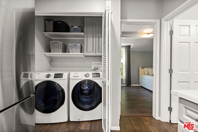 clothes washing area featuring independent washer and dryer and dark wood-type flooring