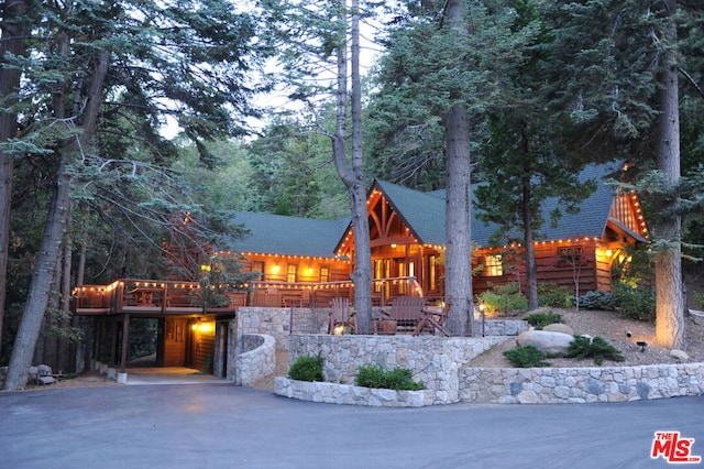 log cabin featuring a deck