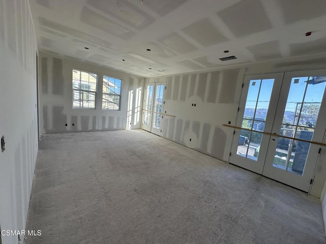 unfurnished room featuring french doors