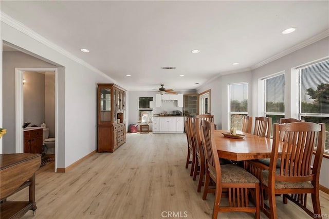 dining room with ceiling fan, light wood-type flooring, and ornamental molding