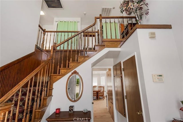 stairway featuring wood walls and hardwood / wood-style floors