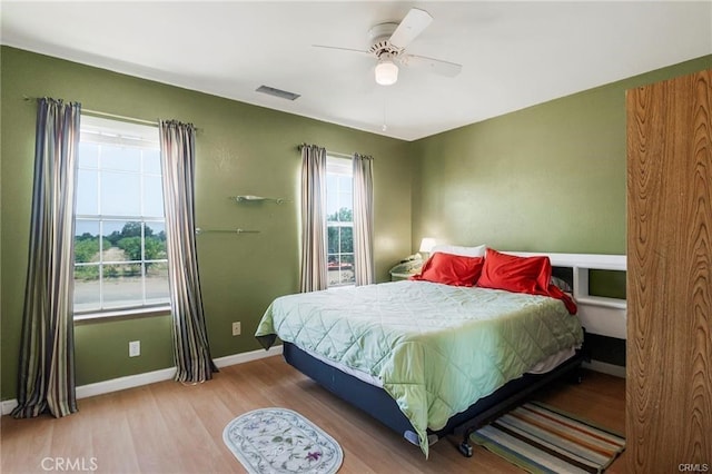 bedroom with ceiling fan and hardwood / wood-style floors