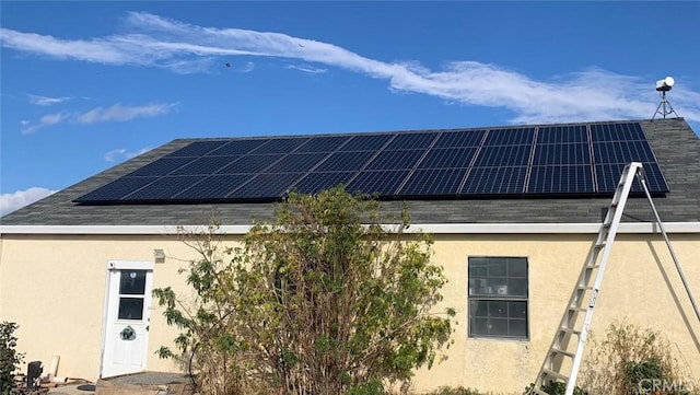 view of property exterior featuring solar panels