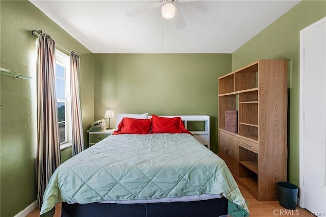 bedroom featuring hardwood / wood-style flooring and ceiling fan