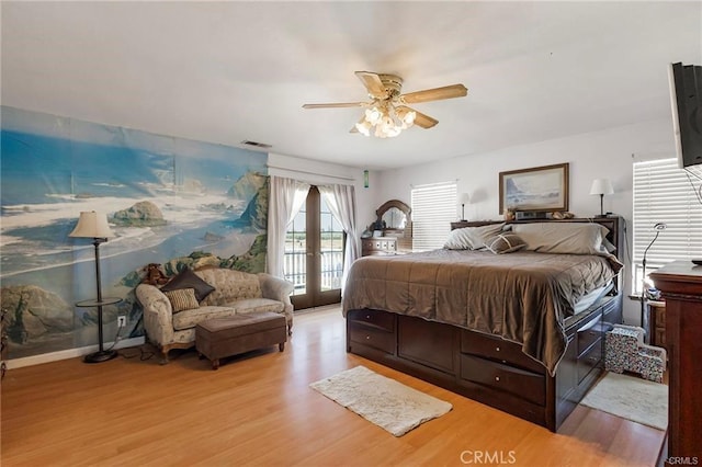 bedroom with access to outside, french doors, light hardwood / wood-style floors, and ceiling fan