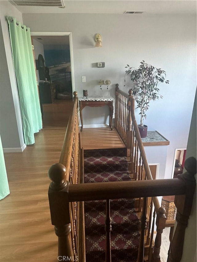 stairway featuring wood-type flooring