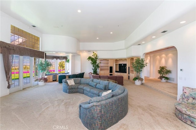 living room with carpet floors and a high ceiling